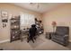 This home office offers a comfortable chair, desk, shelving, and natural light from the window at 4219 E Pinecrest Cir, Las Vegas, NV 89121