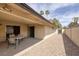 Spacious covered patio with smooth flooring, backyard access, privacy wall and adjacent gravel landscaping, offering outdoor retreat at 4219 E Pinecrest Cir, Las Vegas, NV 89121