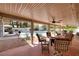Inviting covered patio with ample seating, ceiling fans and view of a refreshing pool and landscaped backyard at 4219 E Pinecrest Cir, Las Vegas, NV 89121