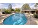 Sparkling pool with a tile border, set against a backdrop of mature trees and a clear blue sky at 4219 E Pinecrest Cir, Las Vegas, NV 89121