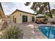 Backyard pool and sun loungers create a relaxing oasis, complemented by lush landscaping and serene privacy at 4219 E Pinecrest Cir, Las Vegas, NV 89121