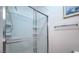 Close-up of a clean shower featuring a glass enclosure and built in shelves at 4725 Basilicata Ln # 204, North Las Vegas, NV 89084