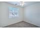 Carpeted room with natural light featuring window with blinds and a ceiling fan at 4725 Basilicata Ln # 204, North Las Vegas, NV 89084