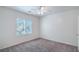 Well-lit bedroom with carpet flooring, ceiling fan, and a large window, ready for personalization at 4725 Basilicata Ln # 204, North Las Vegas, NV 89084