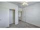 Bedroom featuring carpeted floor, double sliding closet, ceiling fan and a nearby entrance at 4725 Basilicata Ln # 204, North Las Vegas, NV 89084