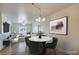 Cozy dining area boasts a modern chandelier and stylish table set at 4725 Basilicata Ln # 204, North Las Vegas, NV 89084