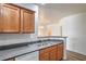 Functional kitchen featuring a stainless steel sink, wooden cabinetry and views to the dining area at 4725 Basilicata Ln # 204, North Las Vegas, NV 89084