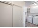 Bright laundry room with machines and a convenient shelving unit for organizing essentials at 4725 Basilicata Ln # 204, North Las Vegas, NV 89084