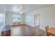 Open concept living room featuring wood floors, bright windows and a ceiling fan at 4725 Basilicata Ln # 204, North Las Vegas, NV 89084