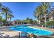 Community swimming pool area with palm trees, lounge chairs, and a covered pavilion at 4725 Basilicata Ln # 204, North Las Vegas, NV 89084