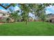Exterior view of a grassy common area between apartment buildings with lush green grass and mature landscaping at 4770 Topaz St # 113, Las Vegas, NV 89121