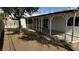 Lush backyard featuring a covered patio and mature shade tree, perfect for outdoor living at 5239 Treasure Ave, Las Vegas, NV 89122