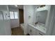 Well-lit bathroom showcasing a marble countertop vanity, bathtub, and wood-style accent wall at 5239 Treasure Ave, Las Vegas, NV 89122