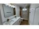 Bathroom features a dual sink marble countertop and updated step-in shower at 5239 Treasure Ave, Las Vegas, NV 89122