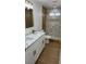 This bathroom features dual sinks, marble countertops, and a step-in shower at 5239 Treasure Ave, Las Vegas, NV 89122