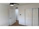 Bedroom with closet, door, and new floors with fresh white paint and modern fan at 5239 Treasure Ave, Las Vegas, NV 89122