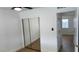 Bright bedroom featuring a mirrored closet, a door to an adjoining room, and light-colored flooring at 5239 Treasure Ave, Las Vegas, NV 89122