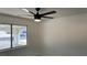 Bedroom featuring light colored walls, a ceiling fan, and a window that provides ample natural light at 5239 Treasure Ave, Las Vegas, NV 89122