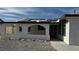 This home boasts a covered porch with stone and stucco details and solar panels on the roof at 5239 Treasure Ave, Las Vegas, NV 89122