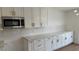 Updated kitchen featuring white cabinets, stainless steel microwave, and marble countertops at 5239 Treasure Ave, Las Vegas, NV 89122