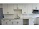 Bright kitchen with white cabinets, stainless steel appliances, and marble countertops at 5239 Treasure Ave, Las Vegas, NV 89122