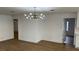 Open-concept living room featuring wood floors and a modern light fixture at 5239 Treasure Ave, Las Vegas, NV 89122