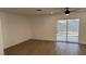 A well-lit bedroom with wood floors and sliding glass door at 5239 Treasure Ave, Las Vegas, NV 89122