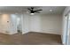 Bright living room features new wood-look flooring, fresh paint, and modern ceiling fan at 5239 Treasure Ave, Las Vegas, NV 89122