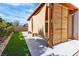 Backyard view of custom wooden patio, artificial turf, and landscaping at 5425 Pride Mountain St, North Las Vegas, NV 89031