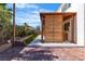 View of backyard with brick pavers and wooden structure at 5425 Pride Mountain St, North Las Vegas, NV 89031