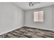 Bright bedroom featuring wood-look flooring, a ceiling fan, and a window providing natural light at 5425 Pride Mountain St, North Las Vegas, NV 89031