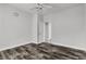 Bedroom with wood-look flooring and a ceiling fan, showcasing a doorway leading to another room at 5425 Pride Mountain St, North Las Vegas, NV 89031