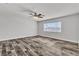 Bright bedroom features a ceiling fan, wood-look floors, and natural light at 5425 Pride Mountain St, North Las Vegas, NV 89031