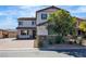 Inviting two-story home with lush landscaping and a brick driveway leading to the garage at 5425 Pride Mountain St, North Las Vegas, NV 89031
