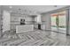 Modern kitchen with white cabinets, granite countertops, island and seamless flow to the outdoor patio at 5425 Pride Mountain St, North Las Vegas, NV 89031