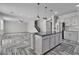 Modern kitchen featuring an island, stainless steel appliances, and stylish countertops at 5425 Pride Mountain St, North Las Vegas, NV 89031