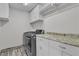 Functional laundry room featuring modern washer and dryer, with granite countertop at 5425 Pride Mountain St, North Las Vegas, NV 89031