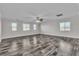 Spacious living room with modern ceiling fan, bright windows, and hardwood flooring at 5425 Pride Mountain St, North Las Vegas, NV 89031