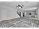 Spacious living area with herringbone floors, stairs, and seamless transition to the modern kitchen at 5425 Pride Mountain St, North Las Vegas, NV 89031