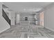 Open concept: stairs, living area and kitchen with herringbone floors and natural light at 5425 Pride Mountain St, North Las Vegas, NV 89031