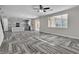 Open living space featuring an open-plan kitchen, herringbone flooring, and ample natural light at 5425 Pride Mountain St, North Las Vegas, NV 89031