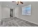 Well-lit living room featuring wood-style floors, a modern ceiling fan, and white trim at 5425 Pride Mountain St, North Las Vegas, NV 89031