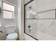 Bathroom with modern tub featuring stylish glass door and white marble at 56 Belle Ridge Ave, Las Vegas, NV 89123