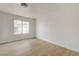 Clean, bright bedroom with light wood floors and a large window at 56 Belle Ridge Ave, Las Vegas, NV 89123