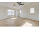 Spacious bedroom featuring a ceiling fan, and a large window with neighborhood views at 56 Belle Ridge Ave, Las Vegas, NV 89123