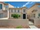 Inviting two-story home features a secure front yard, desert landscaping, and a cozy entrance at 56 Belle Ridge Ave, Las Vegas, NV 89123