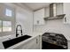 Bright kitchen with white cabinets, stainless steel appliances, and a modern faucet at 56 Belle Ridge Ave, Las Vegas, NV 89123
