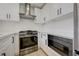 Modern kitchen with stainless steel appliances, white cabinetry, and ample countertop space at 56 Belle Ridge Ave, Las Vegas, NV 89123