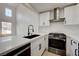 Bright kitchen with white cabinets, stainless steel appliances, and a modern faucet at 56 Belle Ridge Ave, Las Vegas, NV 89123