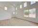 Bright living room with high ceilings, multiple windows, and light wood flooring at 56 Belle Ridge Ave, Las Vegas, NV 89123